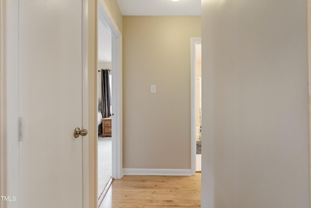 hallway with light hardwood / wood-style flooring