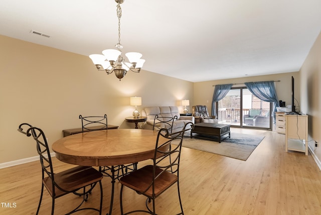 dining area featuring a chandelier and light hardwood / wood-style flooring