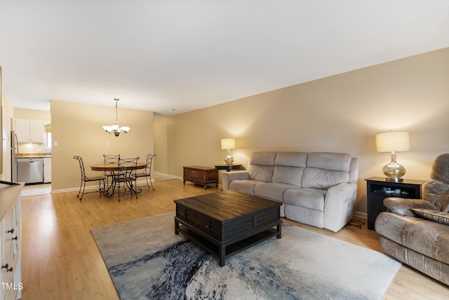 living room with a chandelier and light hardwood / wood-style floors