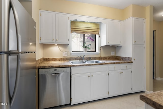 kitchen featuring appliances with stainless steel finishes, sink, and white cabinetry