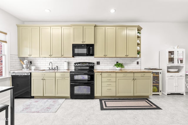 kitchen with sink, backsplash, light tile patterned floors, and black appliances