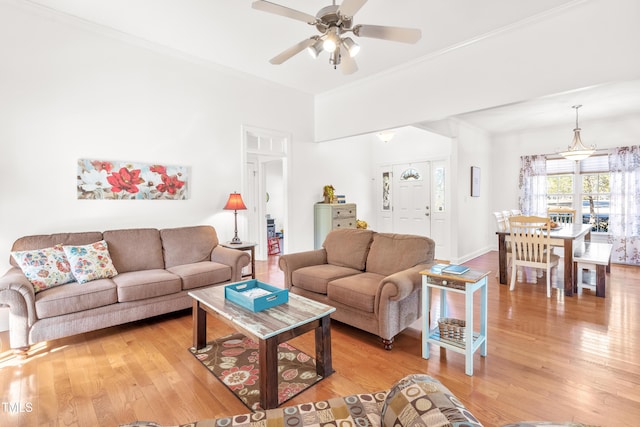 living room featuring ceiling fan, ornamental molding, and hardwood / wood-style floors