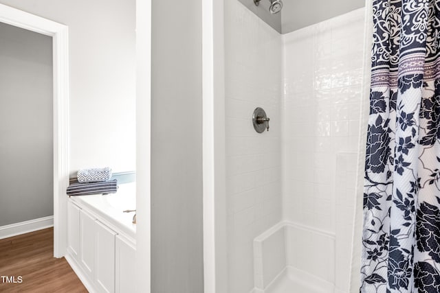 bathroom featuring hardwood / wood-style floors and walk in shower