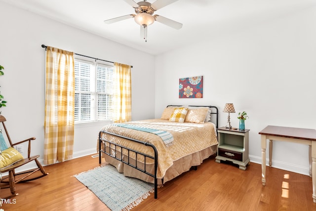 bedroom with ceiling fan and wood-type flooring