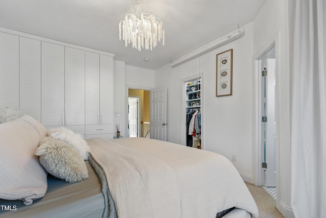 carpeted bedroom featuring a notable chandelier