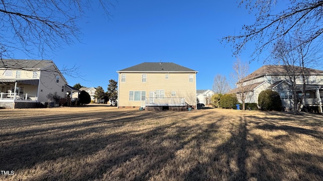 rear view of property with a yard