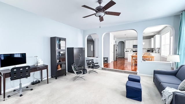 carpeted office with ceiling fan