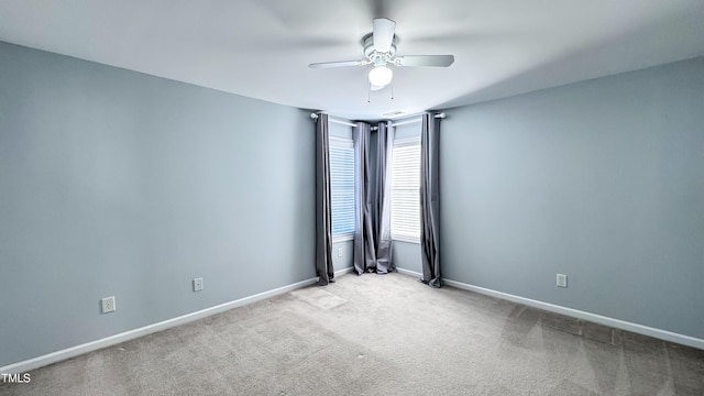 carpeted empty room featuring ceiling fan