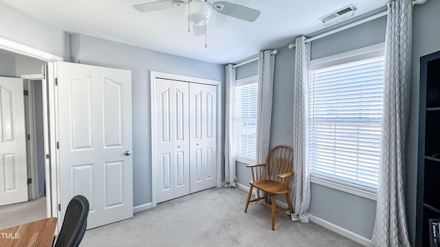 carpeted office space with ceiling fan