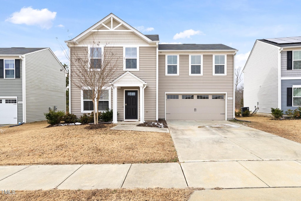 view of front of home with central AC and a garage