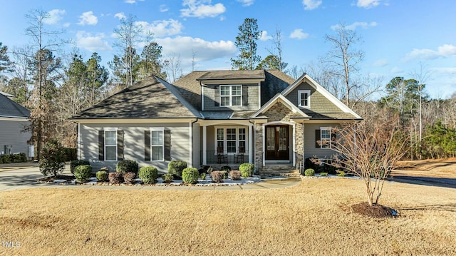 craftsman house with covered porch and a front lawn