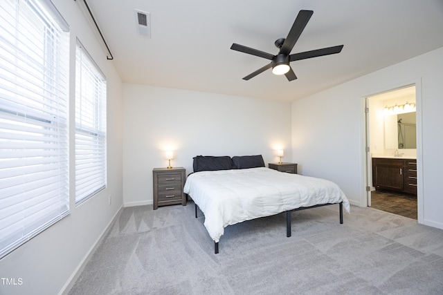 carpeted bedroom featuring ceiling fan and connected bathroom