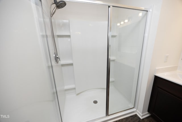 bathroom featuring walk in shower and vanity