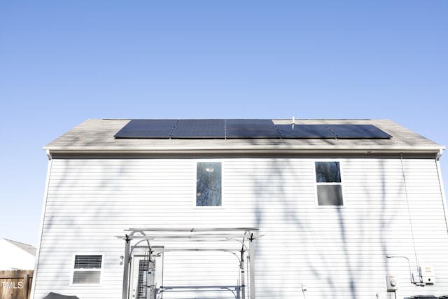 back of house with solar panels