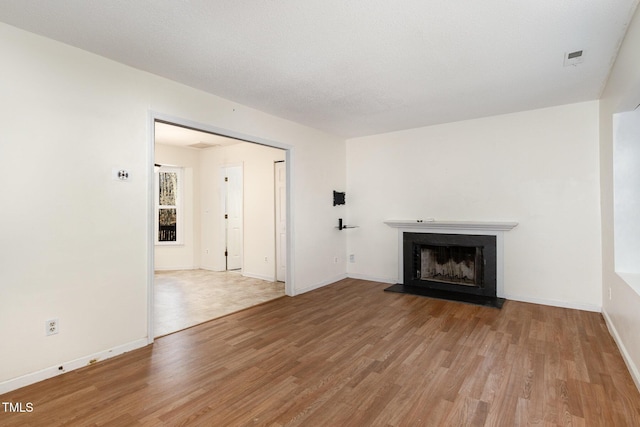 unfurnished living room with light hardwood / wood-style flooring