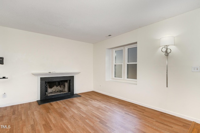 unfurnished living room featuring wood-type flooring