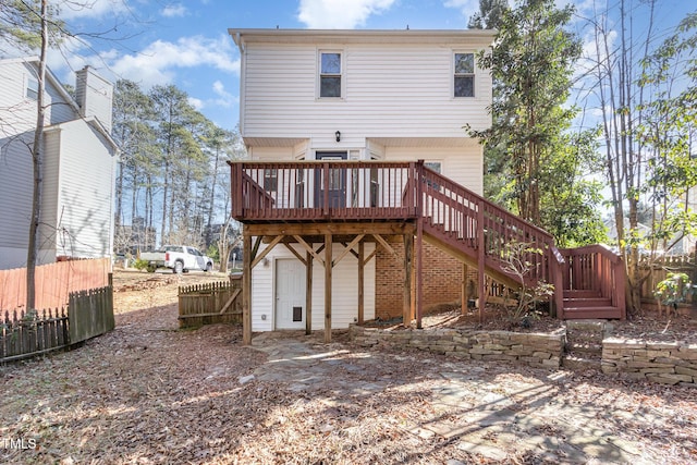 rear view of property with a wooden deck