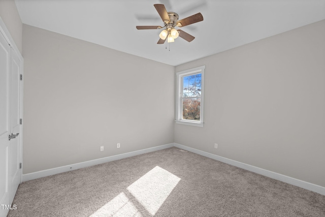 carpeted empty room featuring ceiling fan