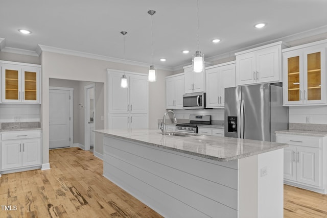 kitchen featuring sink, white cabinets, an island with sink, and appliances with stainless steel finishes