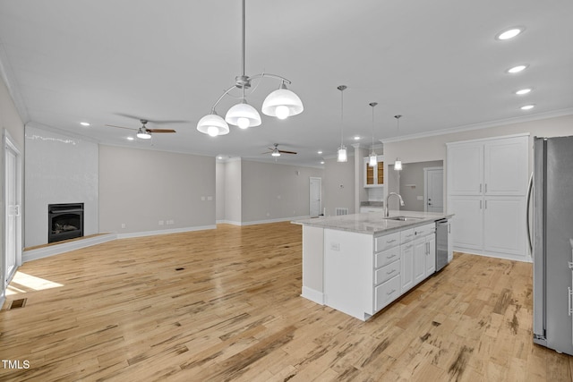 kitchen featuring sink, white cabinetry, an island with sink, pendant lighting, and appliances with stainless steel finishes