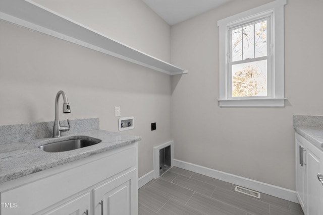 laundry room with sink, cabinets, and hookup for a washing machine