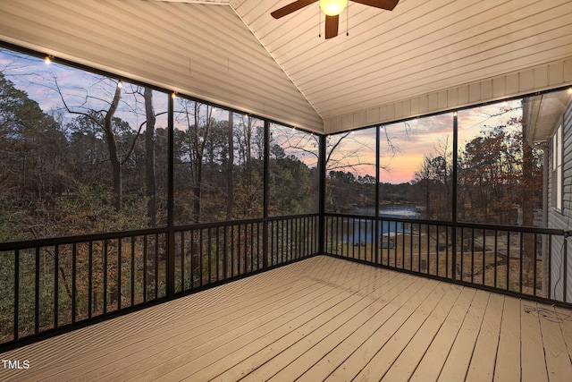 unfurnished sunroom featuring lofted ceiling, ceiling fan, and a water view