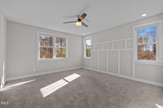 unfurnished room with ceiling fan and carpet floors