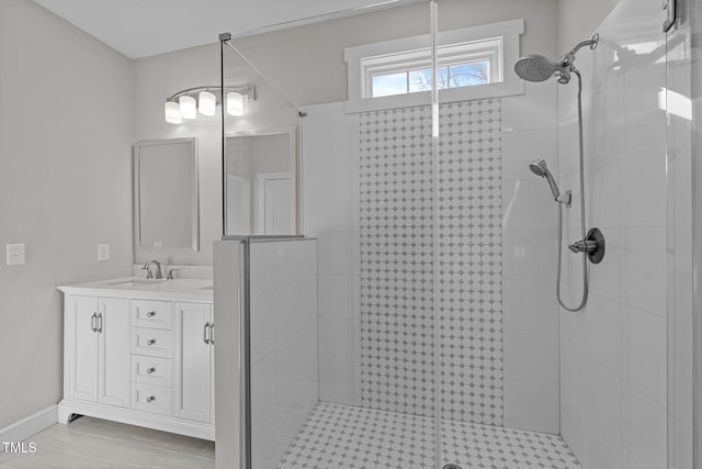 bathroom with a shower with door and vanity