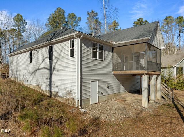 rear view of house featuring a sunroom