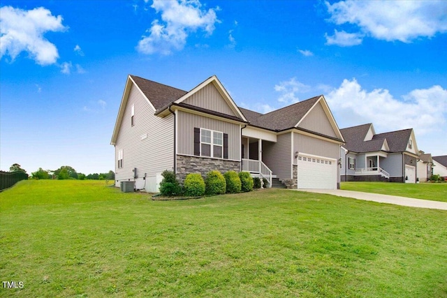 view of front facade featuring a garage, central air condition unit, and a front lawn