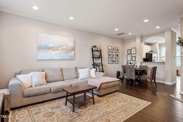 living room with ornamental molding and hardwood / wood-style flooring