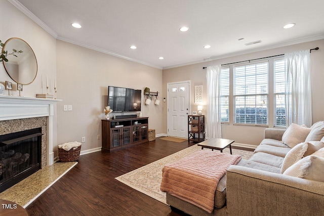 living room with a high end fireplace, dark hardwood / wood-style flooring, and crown molding