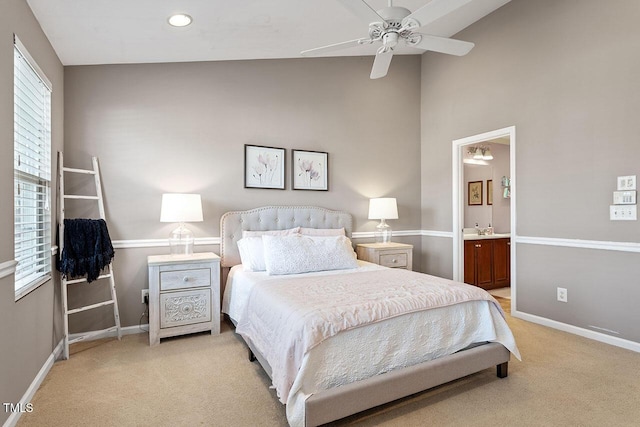 bedroom with ceiling fan, light carpet, sink, and connected bathroom