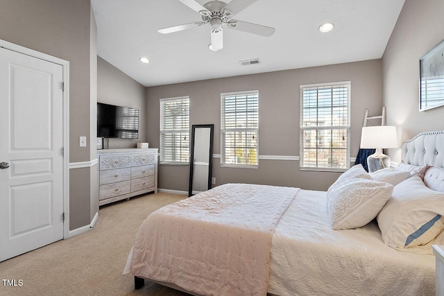 bedroom featuring ceiling fan, lofted ceiling, and light carpet