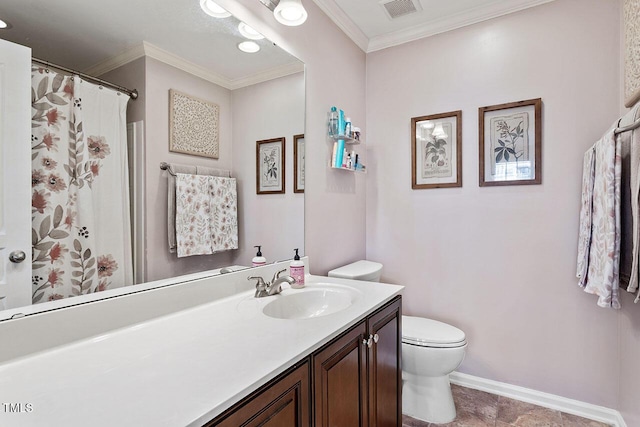 bathroom with toilet, vanity, and ornamental molding