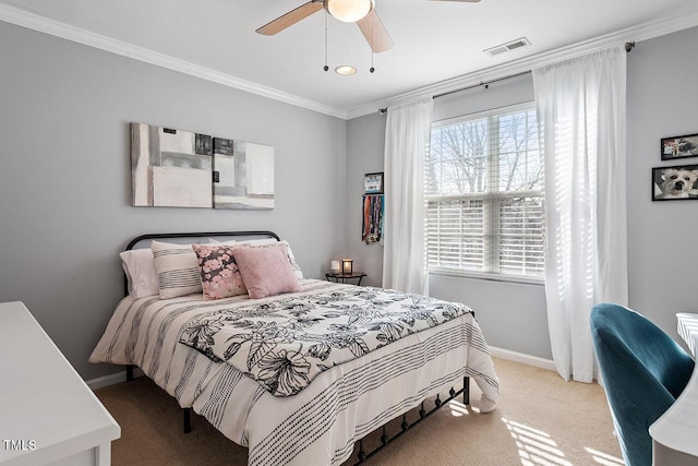 bedroom with ceiling fan, ornamental molding, and carpet floors