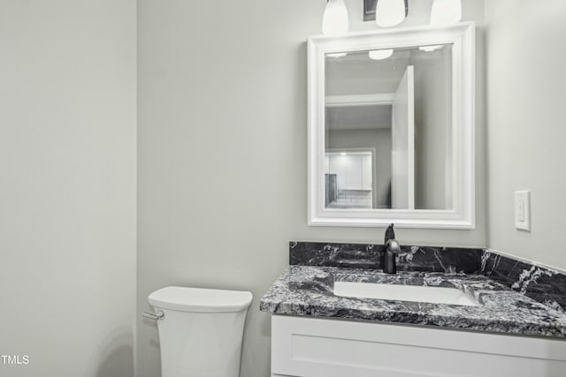 bathroom with toilet and vanity