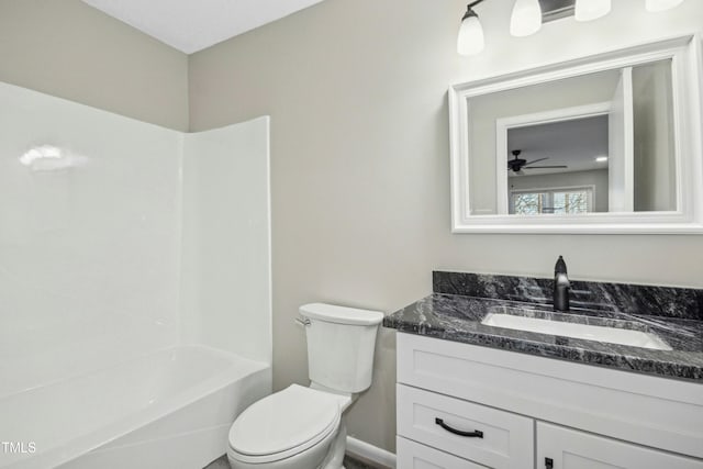 full bathroom featuring ceiling fan, washtub / shower combination, toilet, and vanity