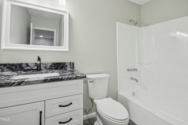 full bathroom with toilet, vanity, and washtub / shower combination