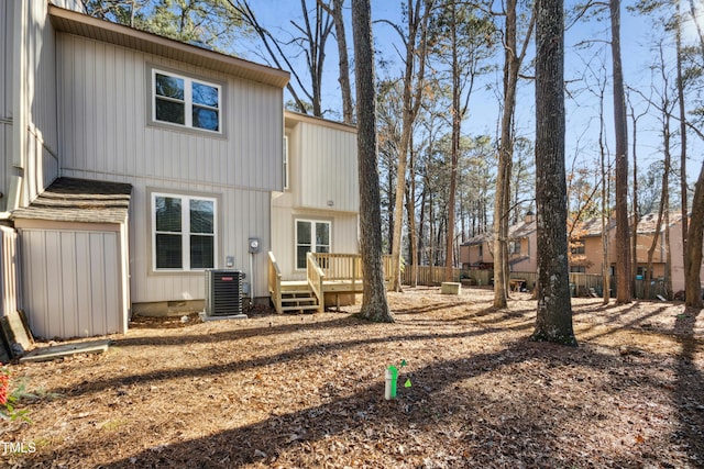 rear view of house with a deck and cooling unit