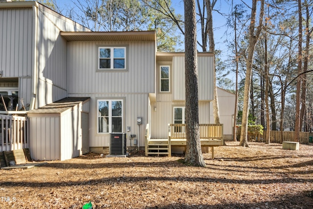 back of property with central AC unit and a wooden deck