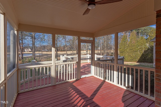 unfurnished sunroom with vaulted ceiling and ceiling fan