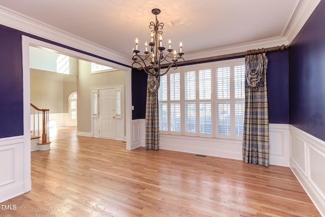 interior space with crown molding, light hardwood / wood-style floors, and a chandelier