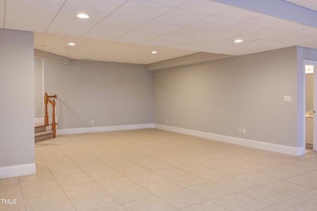 basement featuring a paneled ceiling