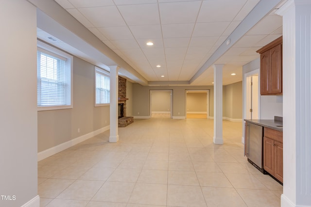 interior space with light tile patterned floors and a fireplace