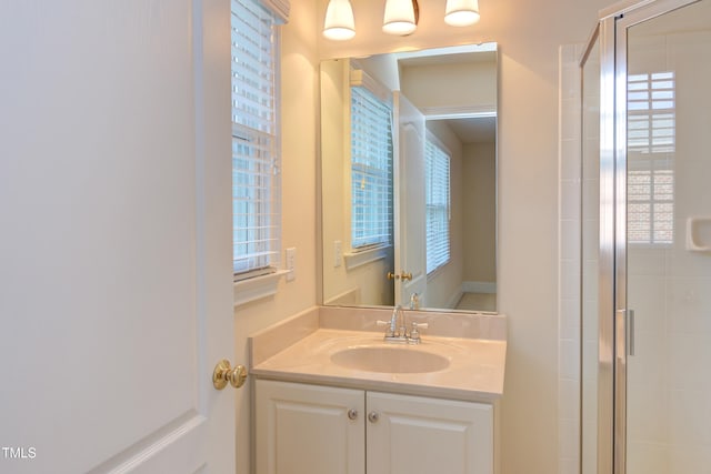 bathroom featuring vanity and a shower with door