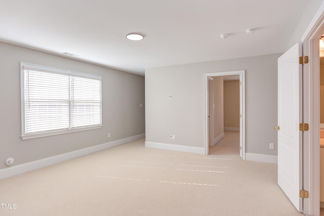 unfurnished room with light carpet