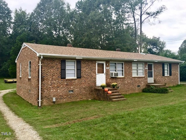 single story home featuring cooling unit, driveway, a front lawn, crawl space, and brick siding