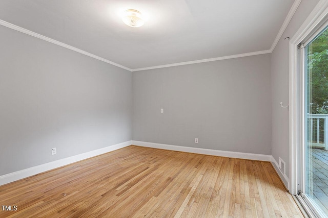 unfurnished room with ornamental molding and light wood-type flooring