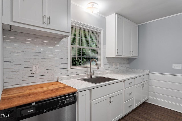 kitchen with sink, white cabinetry, dark hardwood / wood-style floors, decorative backsplash, and stainless steel dishwasher